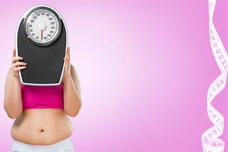 Fat female belly and scale on background
