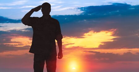 Young military soldier man silhouette on backgroundの写真素材