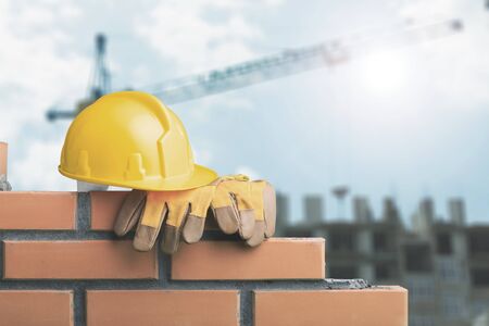 Yellow helmet with equipment on construction backgroundの写真素材
