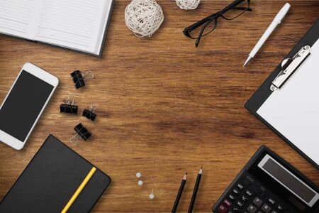 Top view workspace mockup on white background with notebook, pen, coffee, clips and accessories.の写真素材