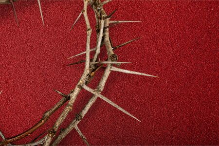 Crown of thorns on red background cloth