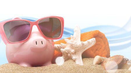 Piggy bank on sandy beach backgroundの写真素材