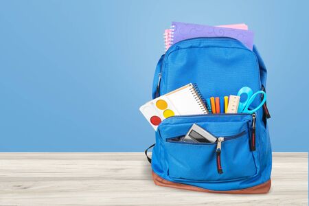 Backpack with different colorful stationery on table. Back to schoolの写真素材