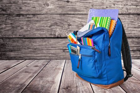 backpack with school supplies including, notebooks, pens, pencils, rulers and glueの写真素材