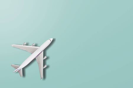 Simply flat lay design miniature toy model plane on blue pastel colorful paper trendy background....
