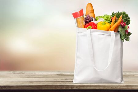 Full shopping  bag, isolated over  backgroundの写真素材