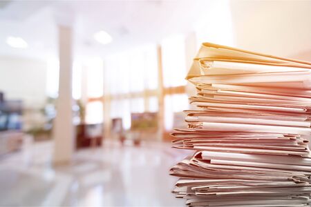 Stack of report paper documents in officeの写真素材