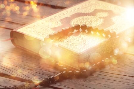 Islamic Book Koran with rosary on backgroundの写真素材