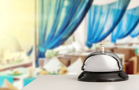 Vintage hotel reception service desk bell on blurred background, bokehの写真素材