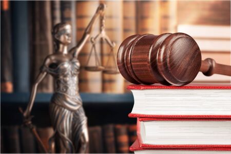 Books and wooden gavel on table. Justice concept