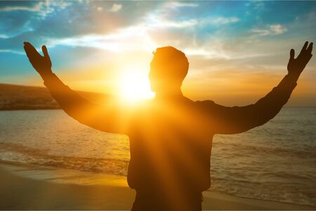 Silhouette man happy with hands rise up on beautiful. Christian praise on hill thanksgiving day background. Man consumed by wanderlust nature standing open arms enjoying sun concept fun wisdom modernの写真素材