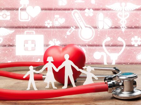 Medical Insurance Concept With Family Cut-out And Stethoscope On Wooden Deskの写真素材