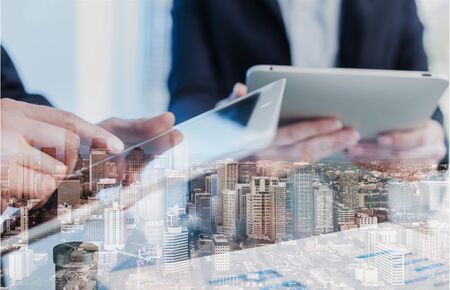 Businessmen in suit working on city background