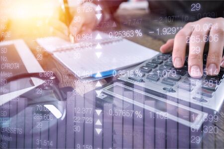 Business modern technology, accounting and finance investment concept. Double exposure of business man working on digital tablet computer and coin with digital diagram, business data, graph interface
    
    - Imageの写真素材