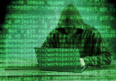 Hacker using laptop. Hacking the Internet.
