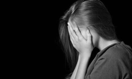 Young woman crying on background