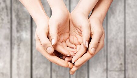 healthcare, medicine and blood donation concept - male and female hands holding hands holding white paper house with red donor signの写真素材