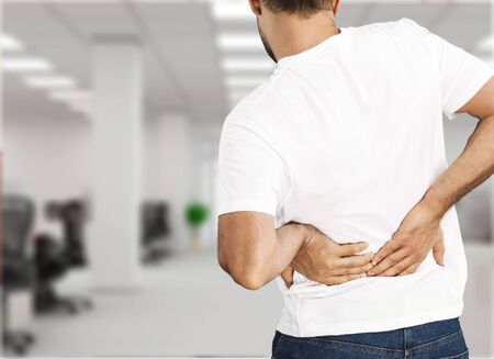 Young man in white shirt with pain