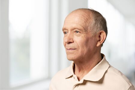 Senior man in blue shirt and glasses