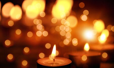 Close up view of the candles cutting through the darkness.の写真素材