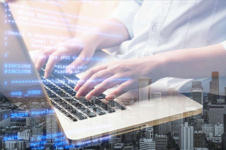 Business and modern technology, double exposure, man programmer coding on laptop computer and smart...