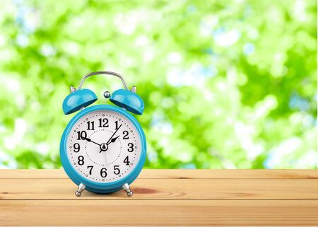 Retro alarm clock on table  background