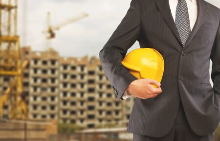 Worker holding his helmetの写真素材