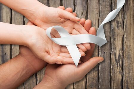 hands holding pink ribbon, breast cancer awareness, October pink conceptの写真素材