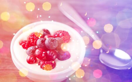 Yogurt with forest berries  on wooden tableの写真素材
