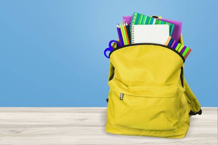 Backpack with different colorful stationery on table. Back to schoolの写真素材