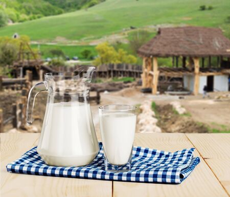 Glass of milk and jug on blurredの写真素材