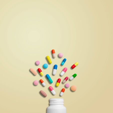 Flat lay composition with bottle, pills and space for text on color background
    
    - Imageの写真素材