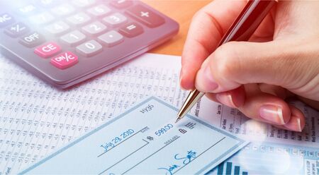 Business man prepare writing a check on background