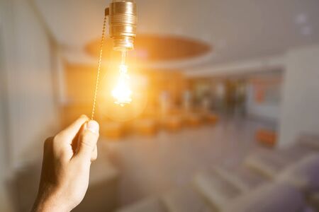 Hand turning off the bulb lamp.Turning offの写真素材