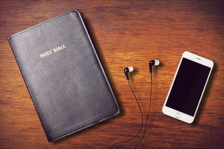 Contemporary image of a Bible with headphonesの写真素材