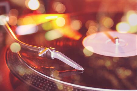 vinyl record on the player close-up and in the sun glareの写真素材