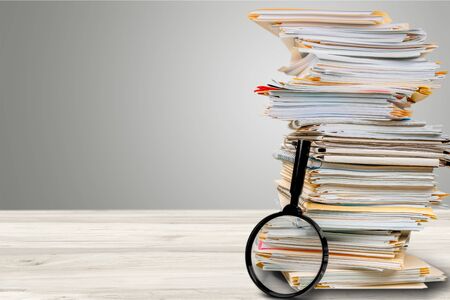 File folders with documents and magnifying glassの写真素材