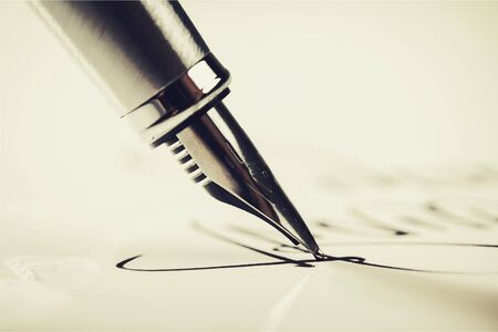 Signing a signature with a fountain penの写真素材