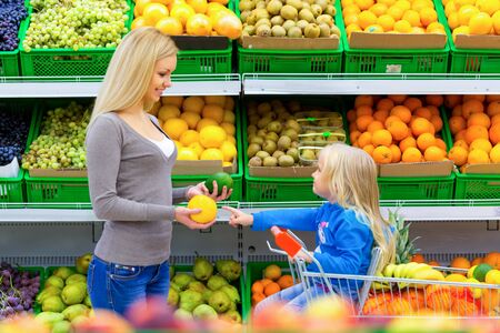Mother and Daughter Shopping in Supermarketの写真素材
