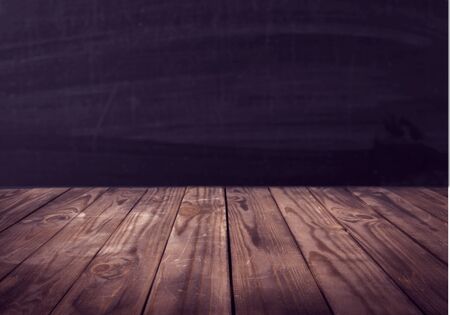 Wooden desk on dark backgroundの写真素材