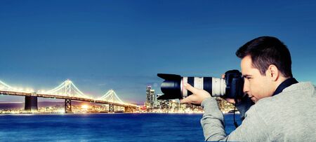 Young photographer taking pictures with a reflex camera