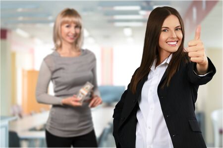 Close-up of a young woman showing thumbs upの写真素材