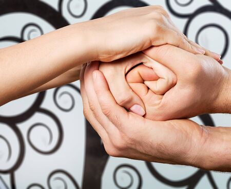 Group of people stacking hands together