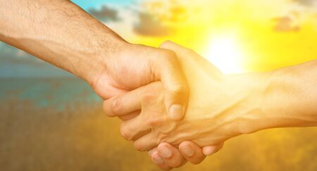 Men hands on sunsetの写真素材