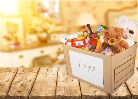 Box Full of Toys and Bears on wooden tableの写真素材