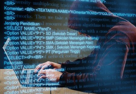 Internet crime concept. Hacker working on a code on dark digital  with digital interface around.