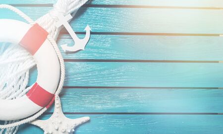 Decorative Lifebuoy and anchor on blue wooden