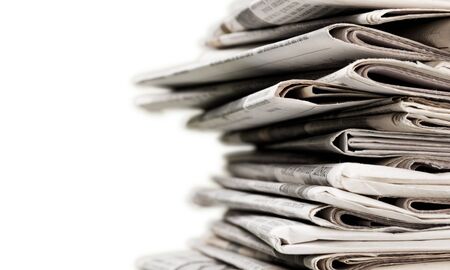 Pile of newspapers on white backgroundの写真素材