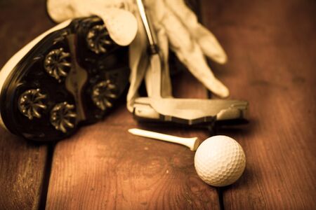 Closeup of Golf Shoe Spikes with Glove, Ball, Tee and Putter