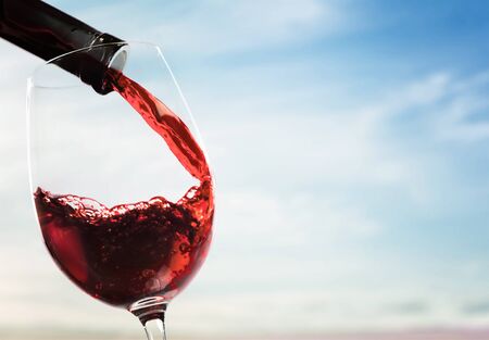 Red wine and glass on backgroundの写真素材